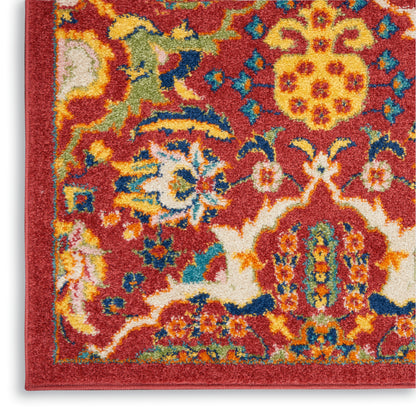Red oriental rug with vivid multicolor floral pattern in yellow, blue, cream and green, decorative border, plush texture.