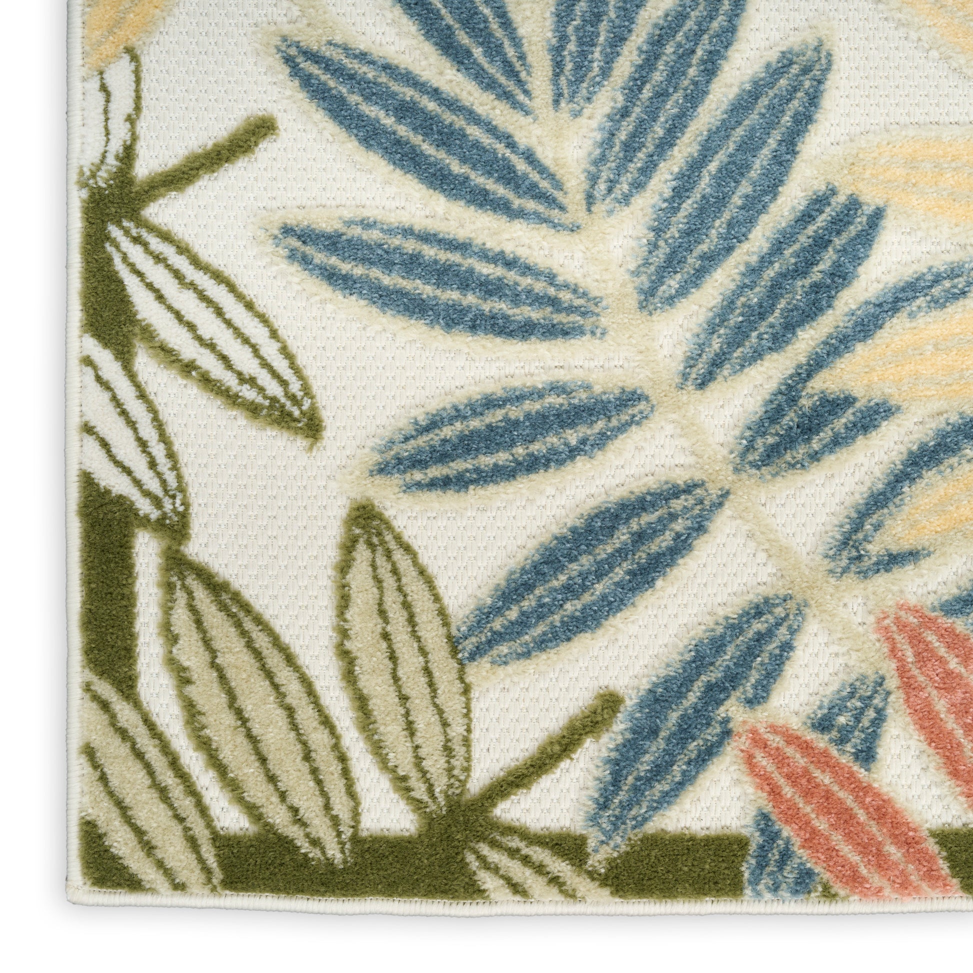 Close-up of botanical textile with blue, olive green, and coral leaves on cream background; woven fabric with edge.