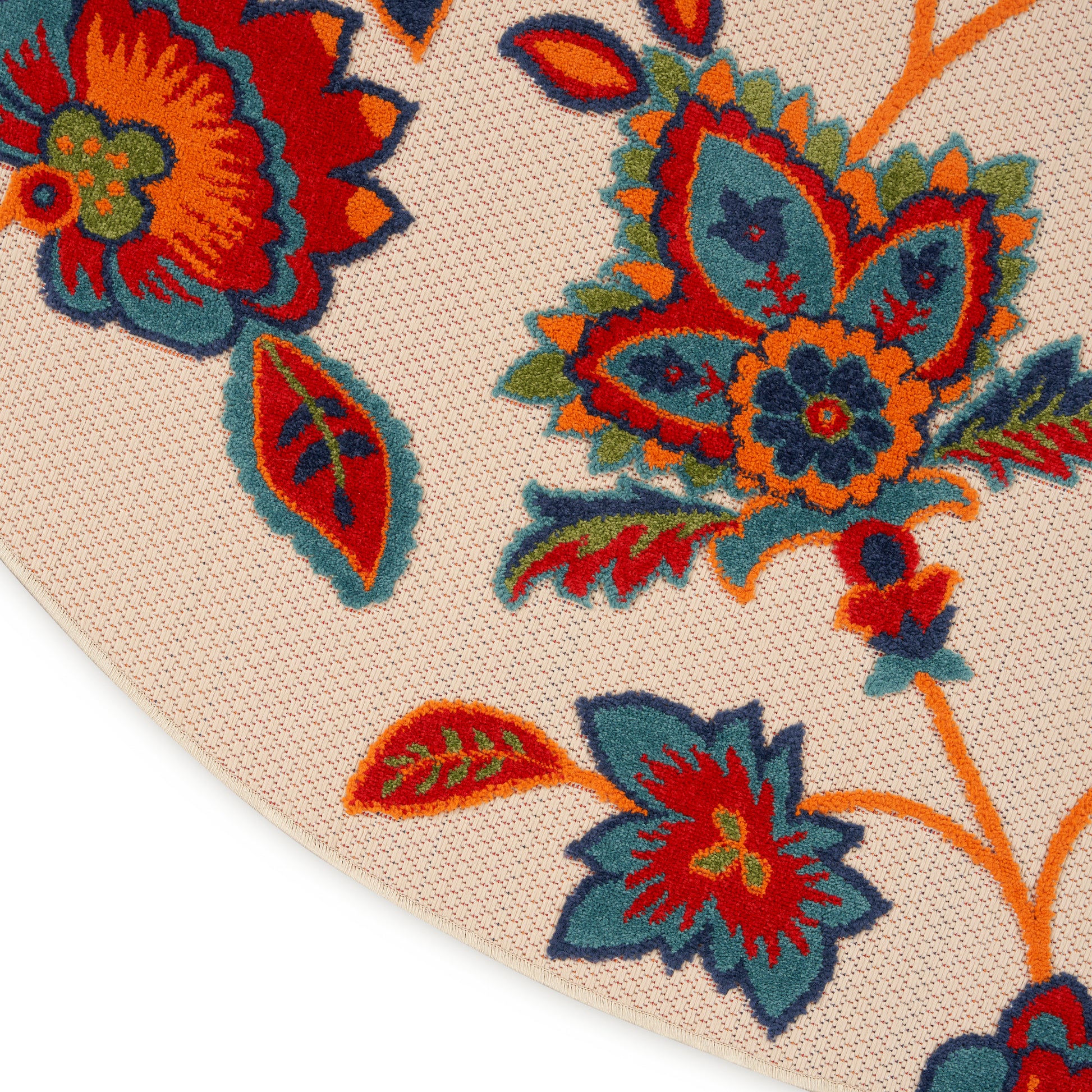 Beige woven textile with vibrant multicolor floral embroidery in red, orange, teal and blue; curved edge, boho folk style.