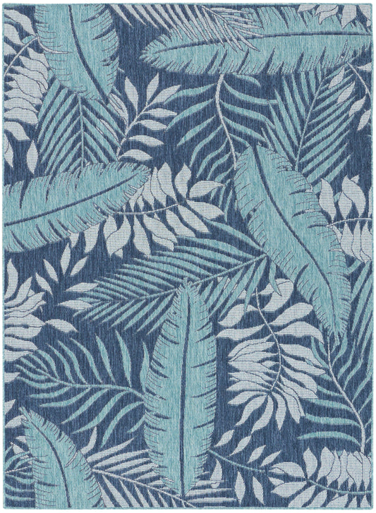 Rectangular woven rug with teal and light-blue tropical leaves on a dark navy background.