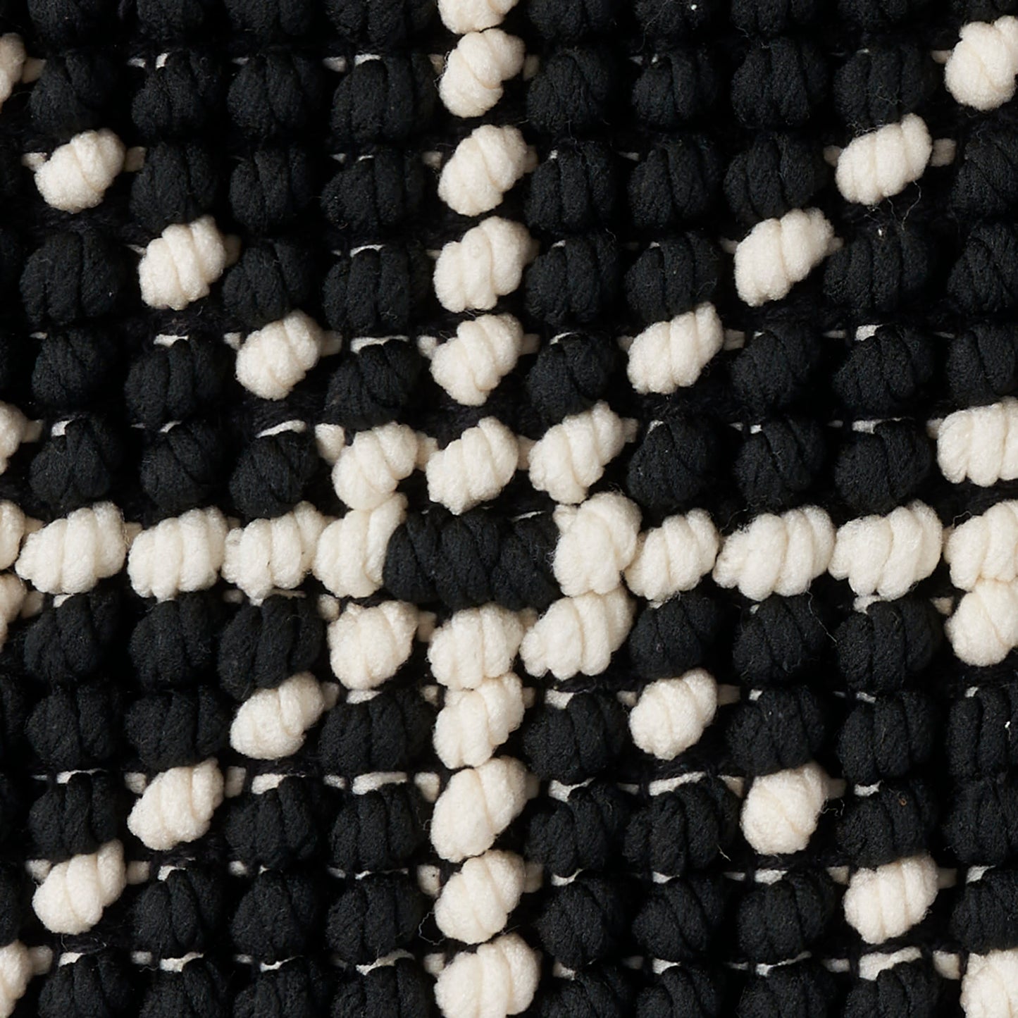 Chunky black and white boucle knit rug with knobby loops in a checker pattern, 20" x 20