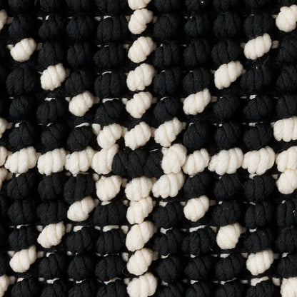 Chunky black and white boucle knit rug with knobby loops in a checker pattern, 20" x 20