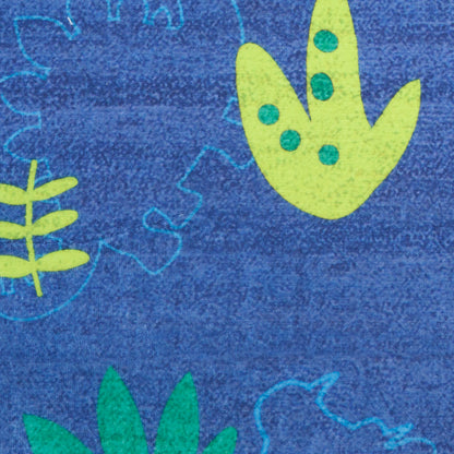 Blue rug with lime-green abstract leaf motifs and dotted accents.