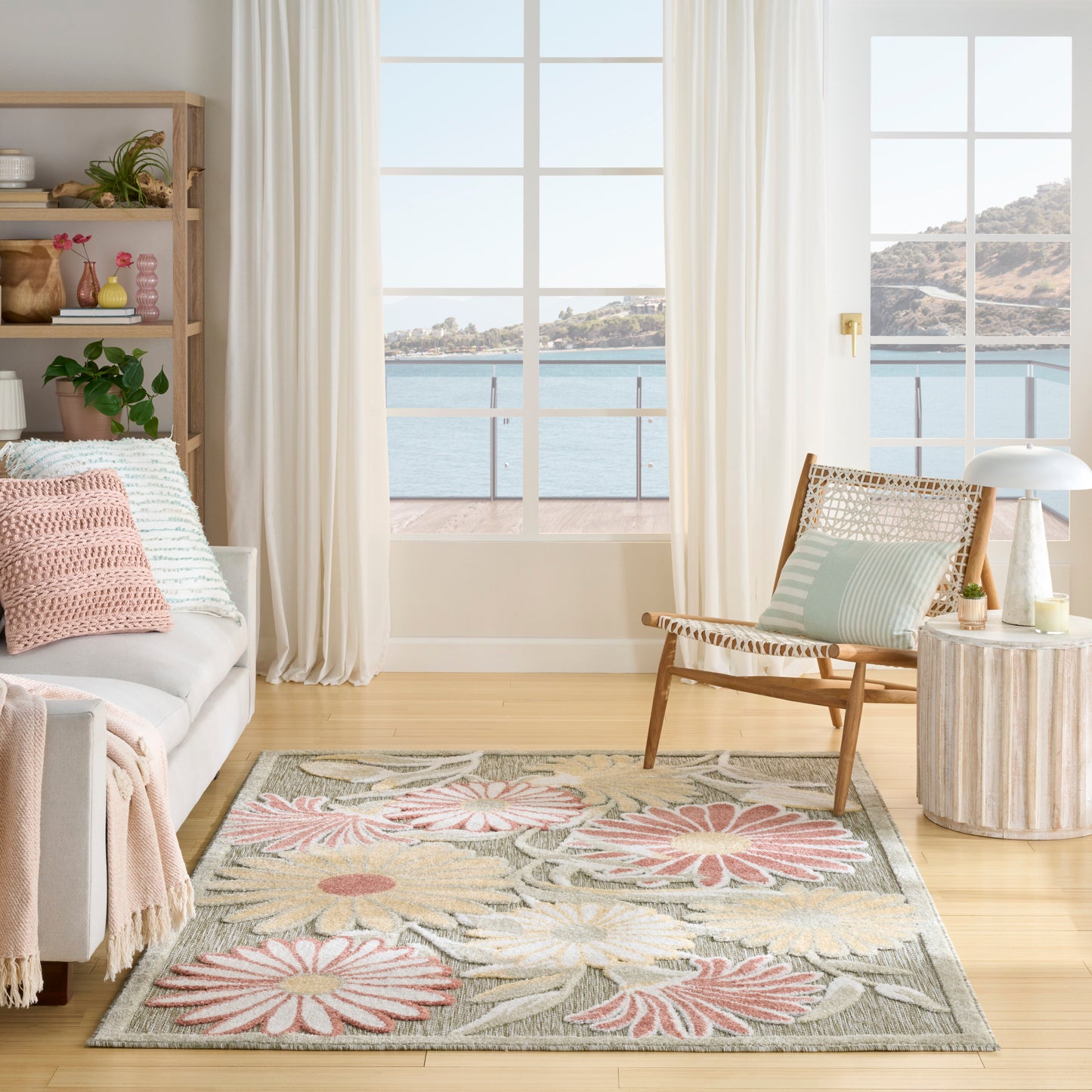 Soft, tufted pastel floral outdoor rug with pink, green and beige petals.