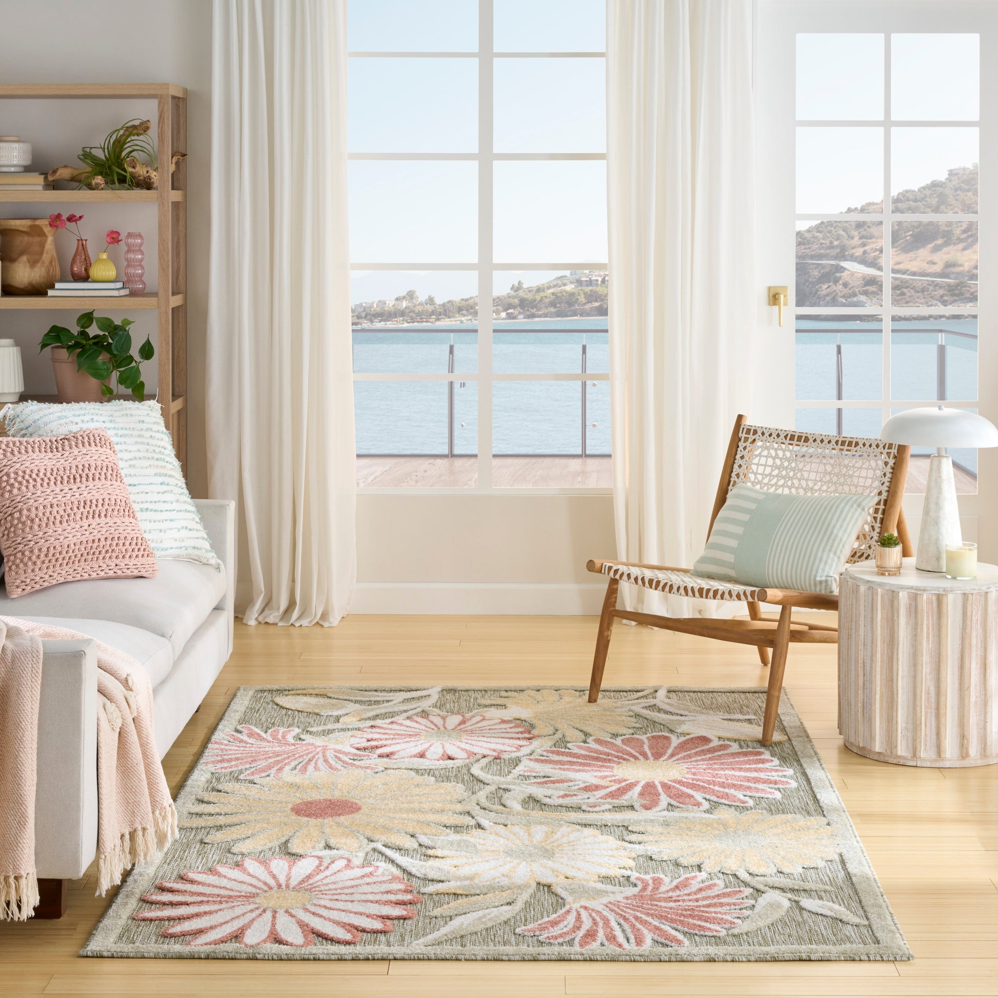 Soft, tufted pastel floral outdoor rug with pink, green and beige petals.