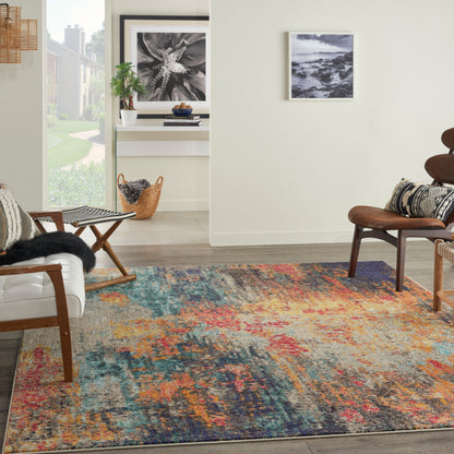 Modern living room with a vibrant abstract rug, mid-century chairs, potted plant, and framed black-and-white art.