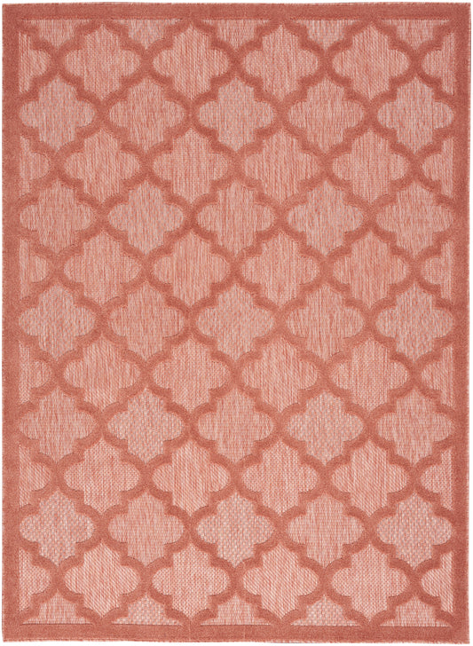 Rectangular coral rug featuring a textured trellis lattice pattern in matching shade, woven surface.