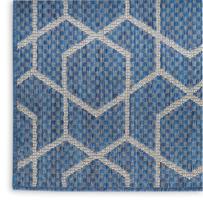 Blue woven rug with white geometric diamond lattice pattern; textured, rectangular area rug for living room or entryway.