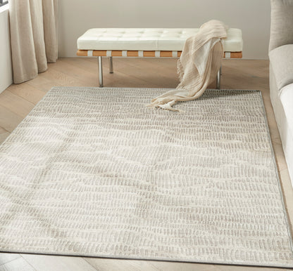 Neutral ivory-gray textured area rug with a subtle wavy pattern; modern living-room essential.
