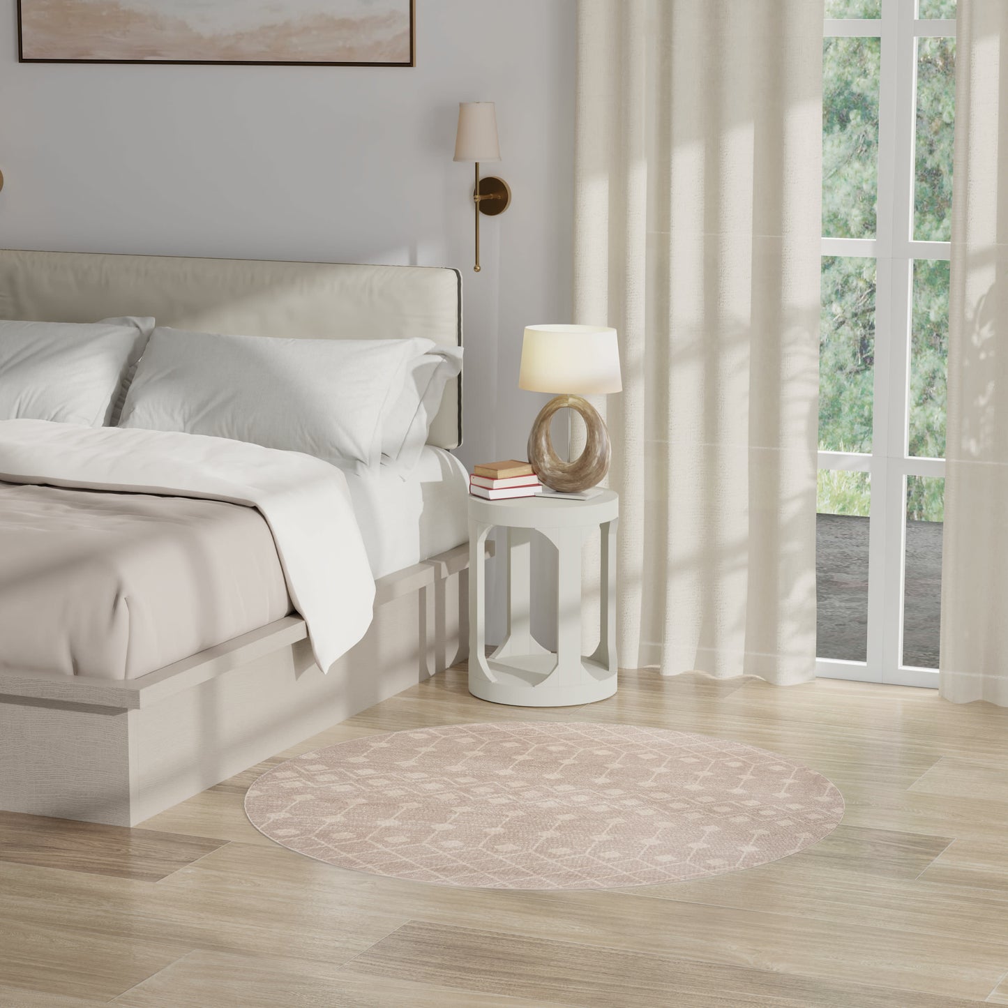 Neutral-toned bedroom with cream upholstered bed, white bedding, round blush rug, white side table, lamp and books, curtains.