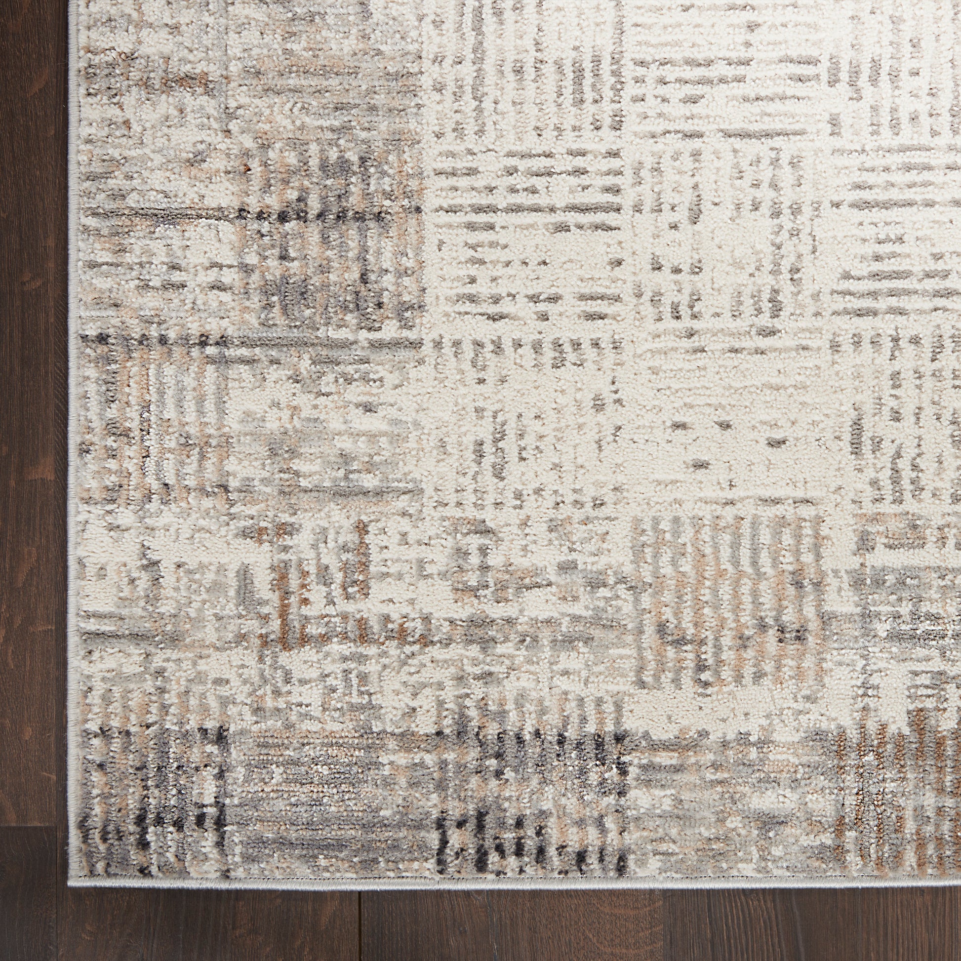 Rectangular neutral-toned 6' runner rug with patchwork blocks in beige, taupe and gray; modern distressed style, shown on dark wood floor.