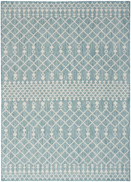 Blue woven rug with white lattice diamonds and dotted bands; rectangular, modern decor.