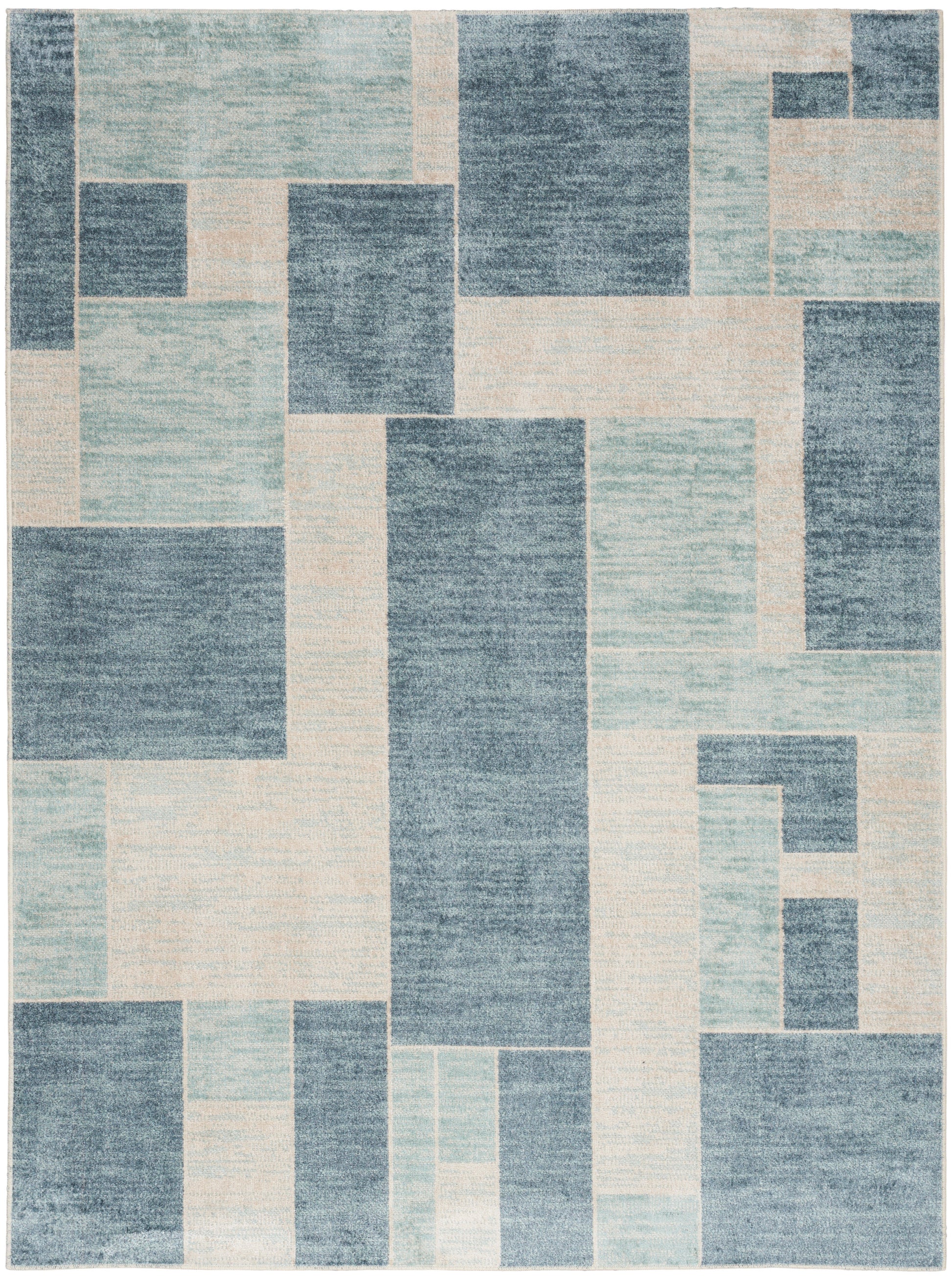 Geometric patchwork rug in blue and cream tones with rectangular blocks; modern contemporary style.