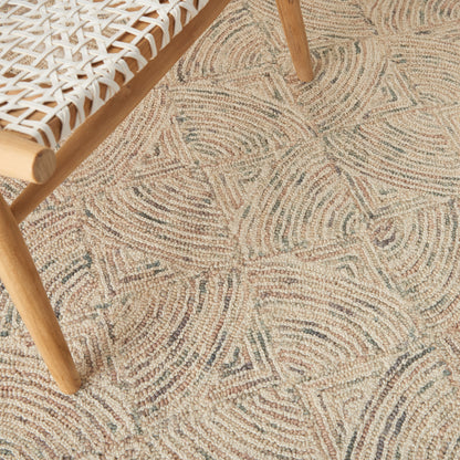 Light wooden chair with a white woven lattice seat atop a beige geometric rug with circular swirl motifs.