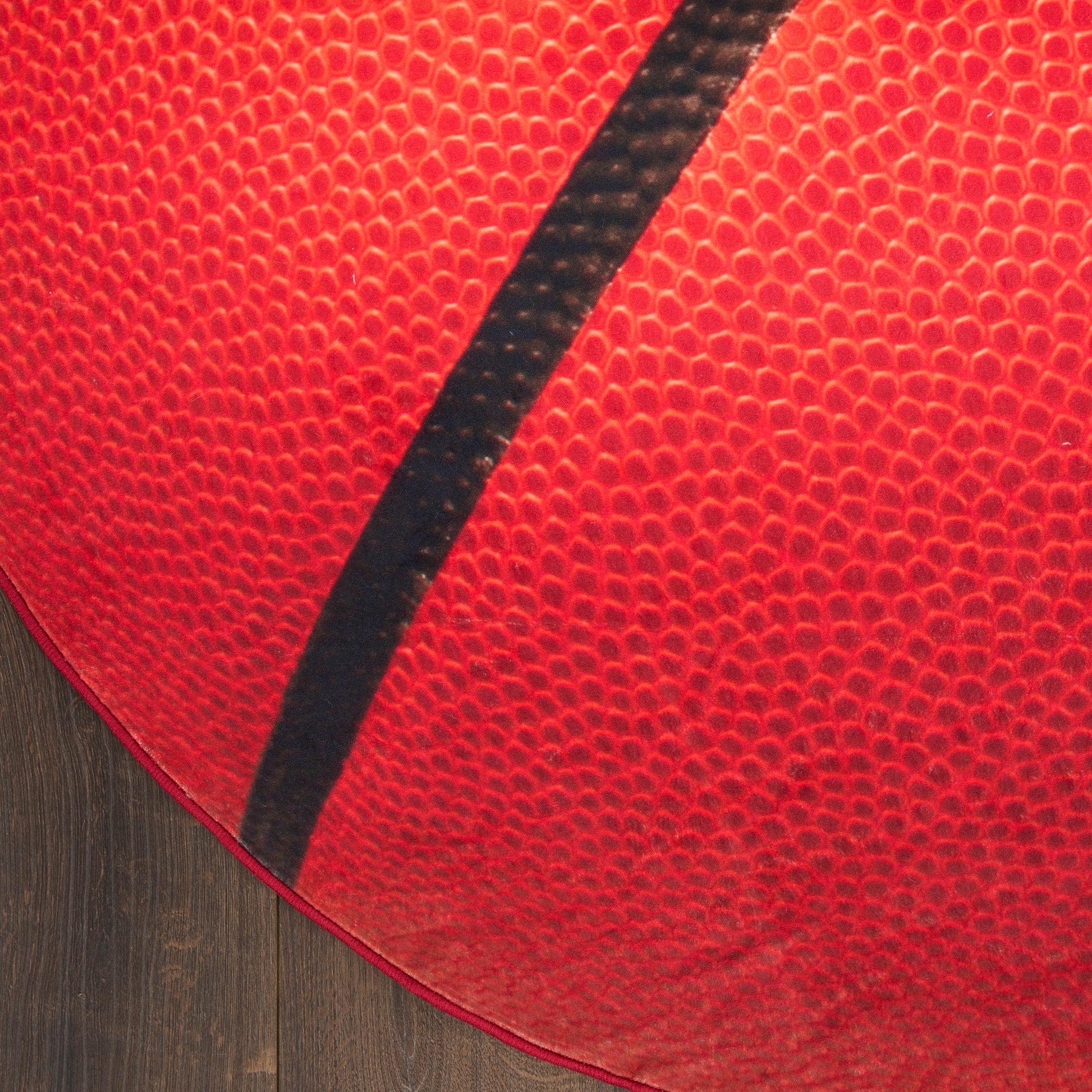 Close-up of a round rug on a wooden floor.