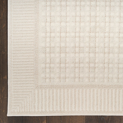 Rectangular beige area rug with woven grid pattern and striped borders in cream & taupe on dark wood floor.