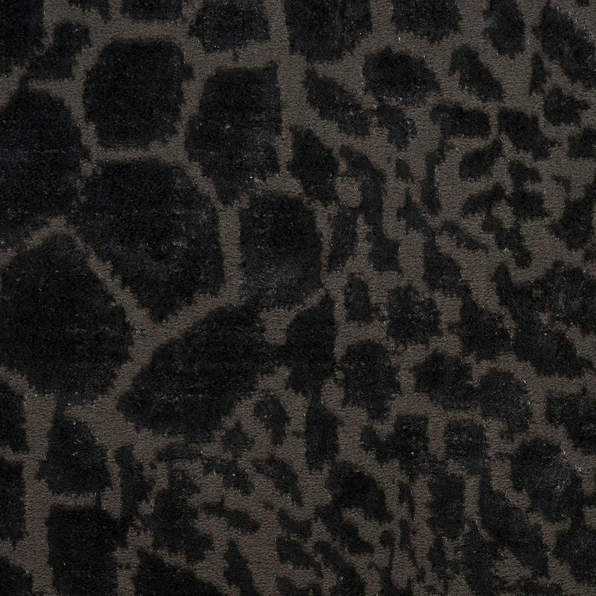 Dark leopard-print plush fabric in black and brown, faux fur-like texture for clothing or decor.