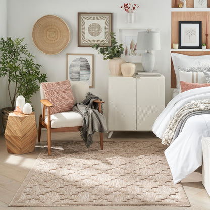 Neutral-toned bedroom with beige geometric rug, white bedding, wooden armchair, potted plant, wall art, and ceramic vases.