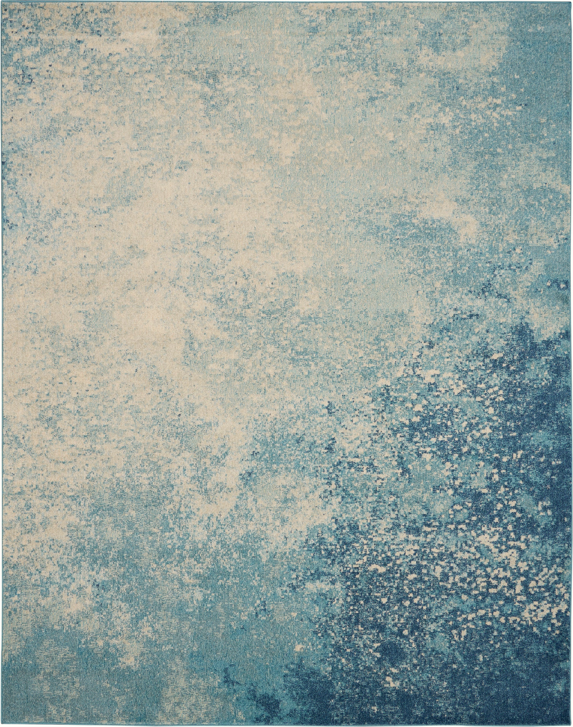 Abstract blue-teal area rug with cream speckle pattern and distressed gradient for contemporary living rooms.