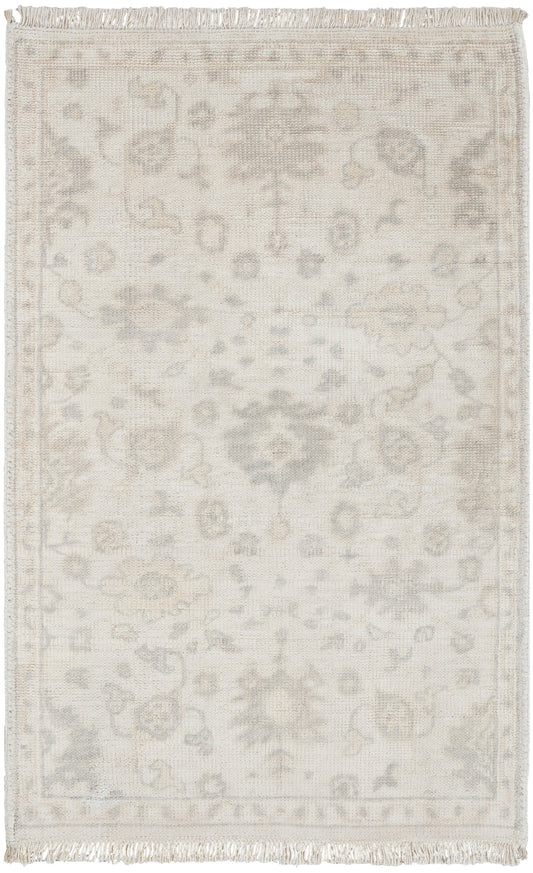 Cream Persian-style area rug with pale grey floral medallion pattern and fringed edges.