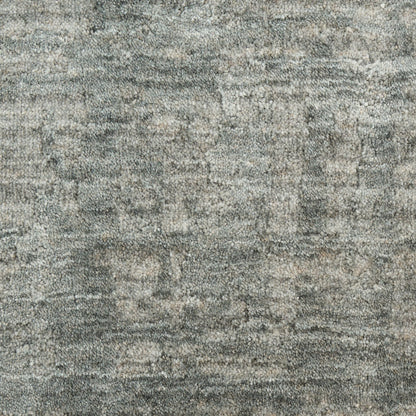 Gray textured rug with subtle beige flecks and a dense loop pile.