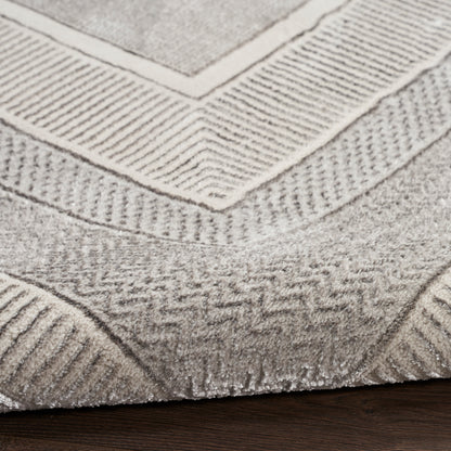 Neutral gray-beige geometric rug with chevron and ribbed border patterns; woven, low-pile.