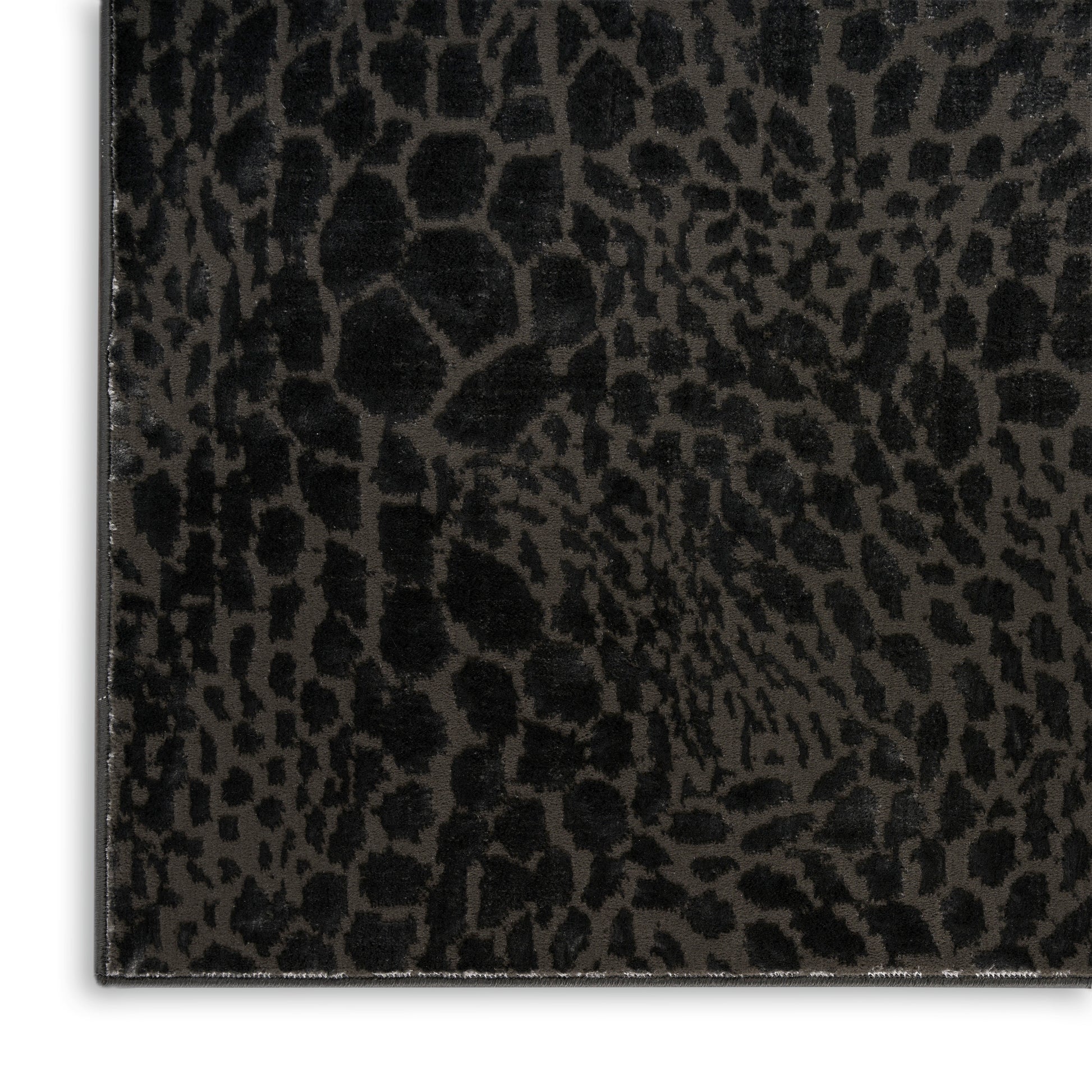 Close-up of black leopard-print faux leather texture with subtle sheen and edge stitching.