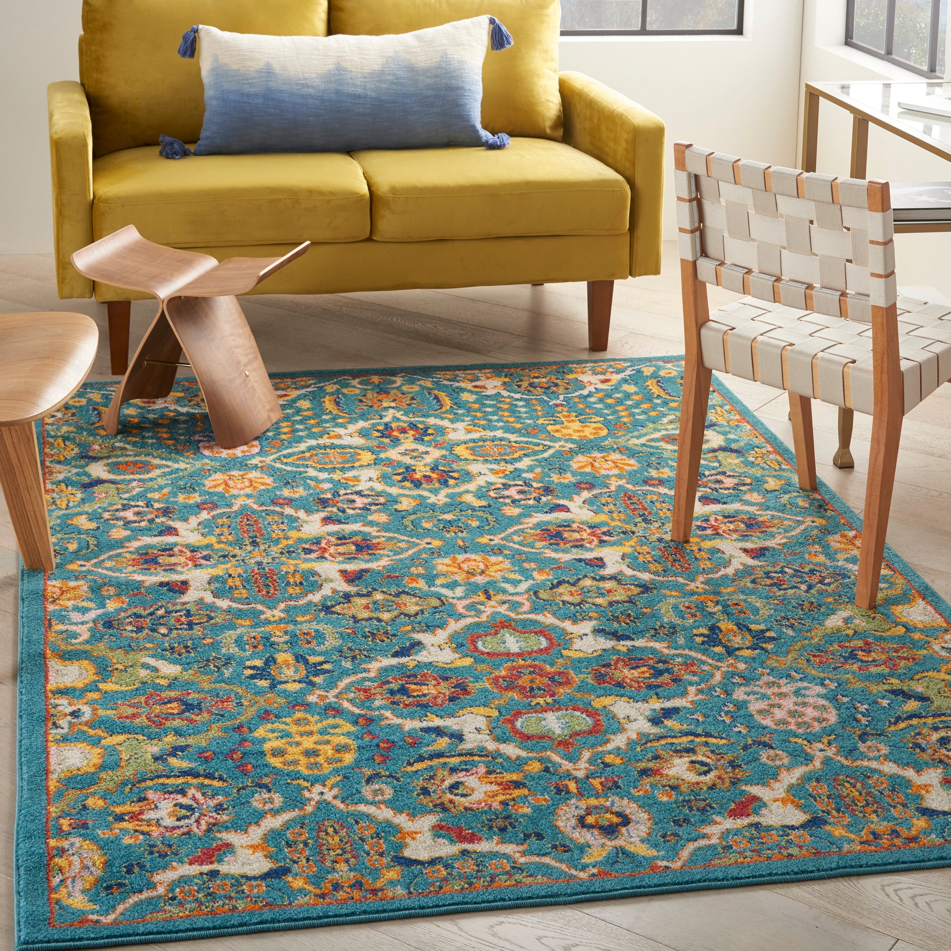 Teal floral Bohemian area rug on a sunlit living room floor (6' x 9').