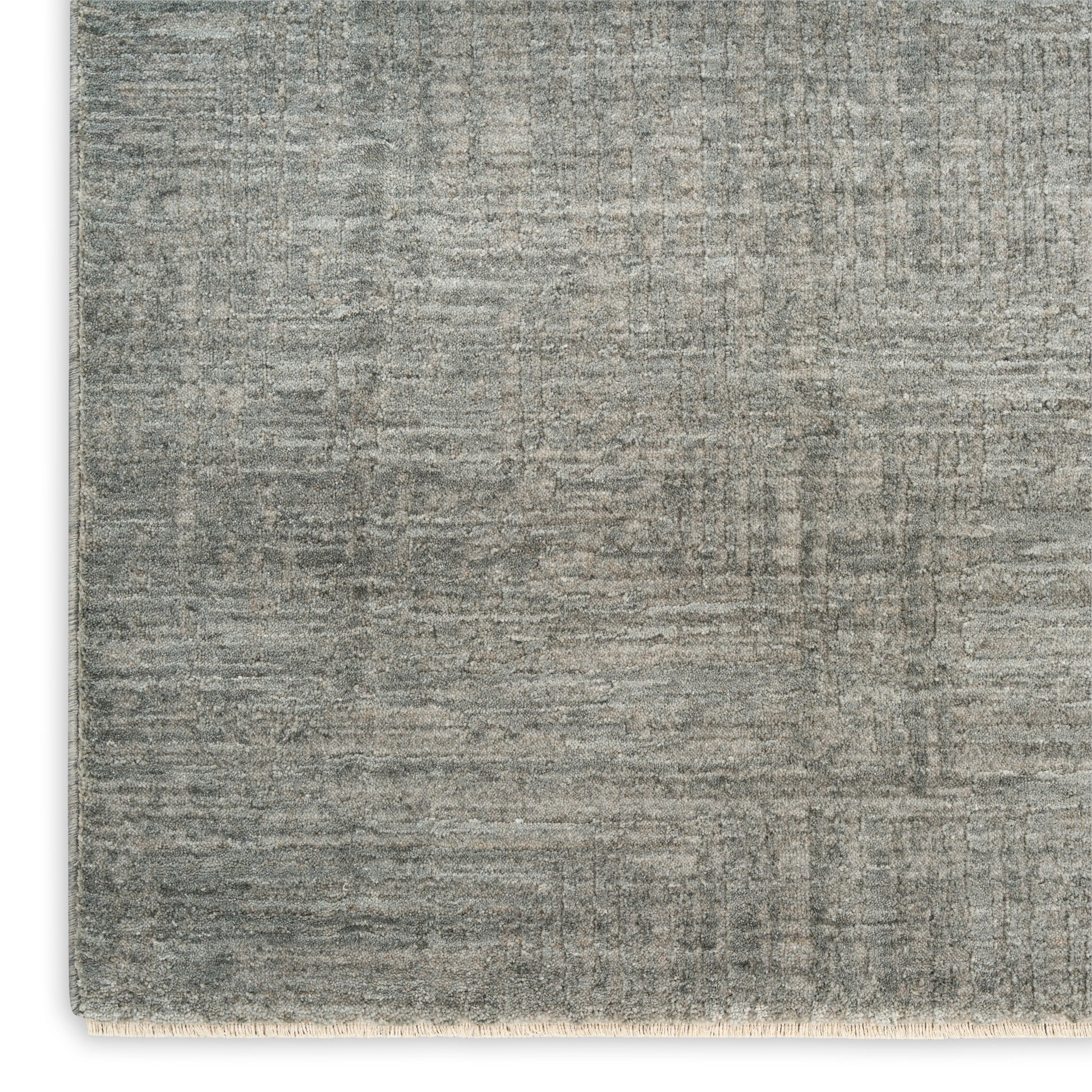 Gray textured rectangular rug with subtle distressed pattern and beige fringe along the bottom edge