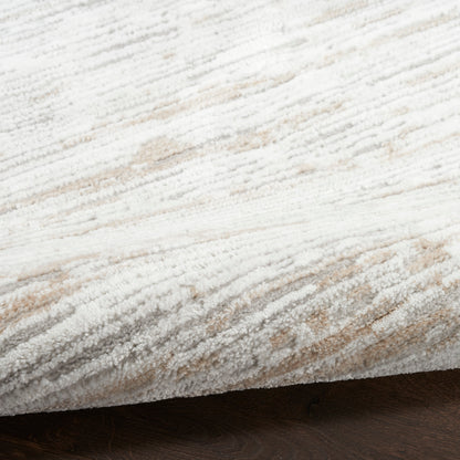 Cream-beige textured rug with plush pile and subtle gray stripes, rolled edge on dark wood floor.