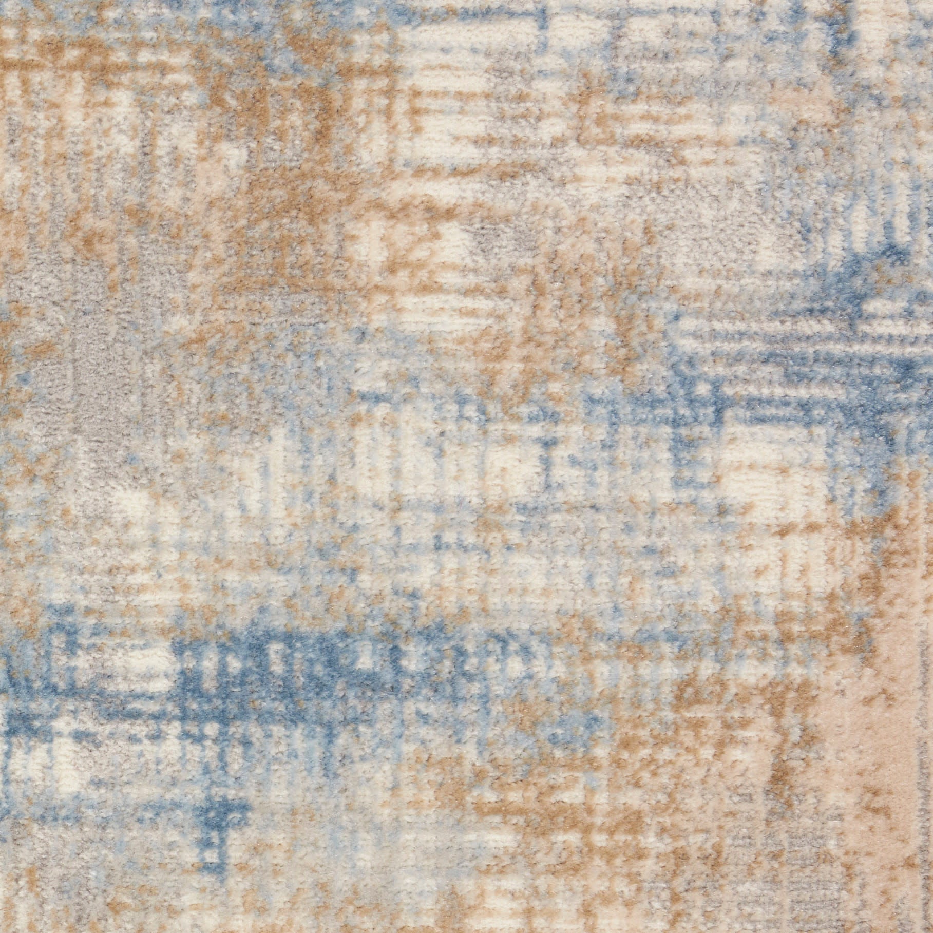 Abstract distressed area rug with blue, beige and cream tones in a geometric pattern.