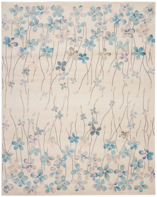 Beige area rug with blue and pink watercolor flowers on slender stems, airy botanical pattern for living room decor.