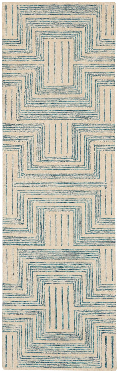 Beige runner rug with teal stepped-square spirals; geometric modern pattern and soft textured pile.