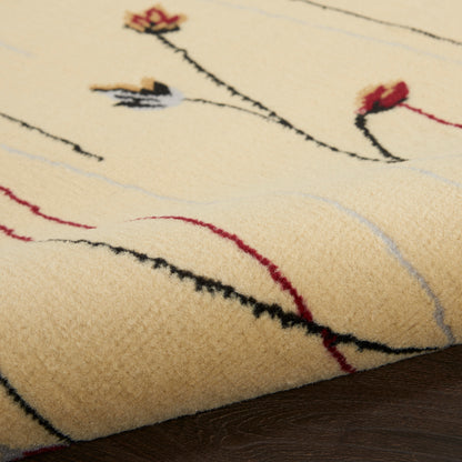 Cream wool rug with abstract black, red, and gray curved lines and small floral accents; laid on a wooden floor.