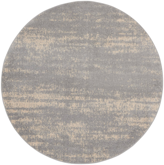 Round gray rug with a beige distressed brushstroke pattern in a modern minimalist style.