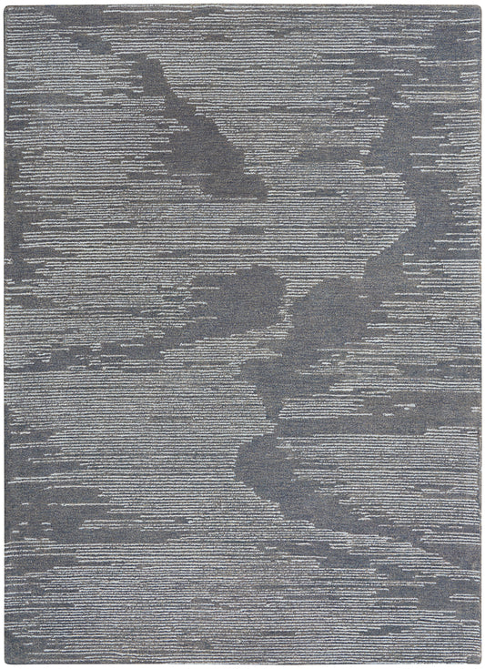 Rectangular gray area rug with abstract darker shapes and fine horizontal striations; modern woven texture.