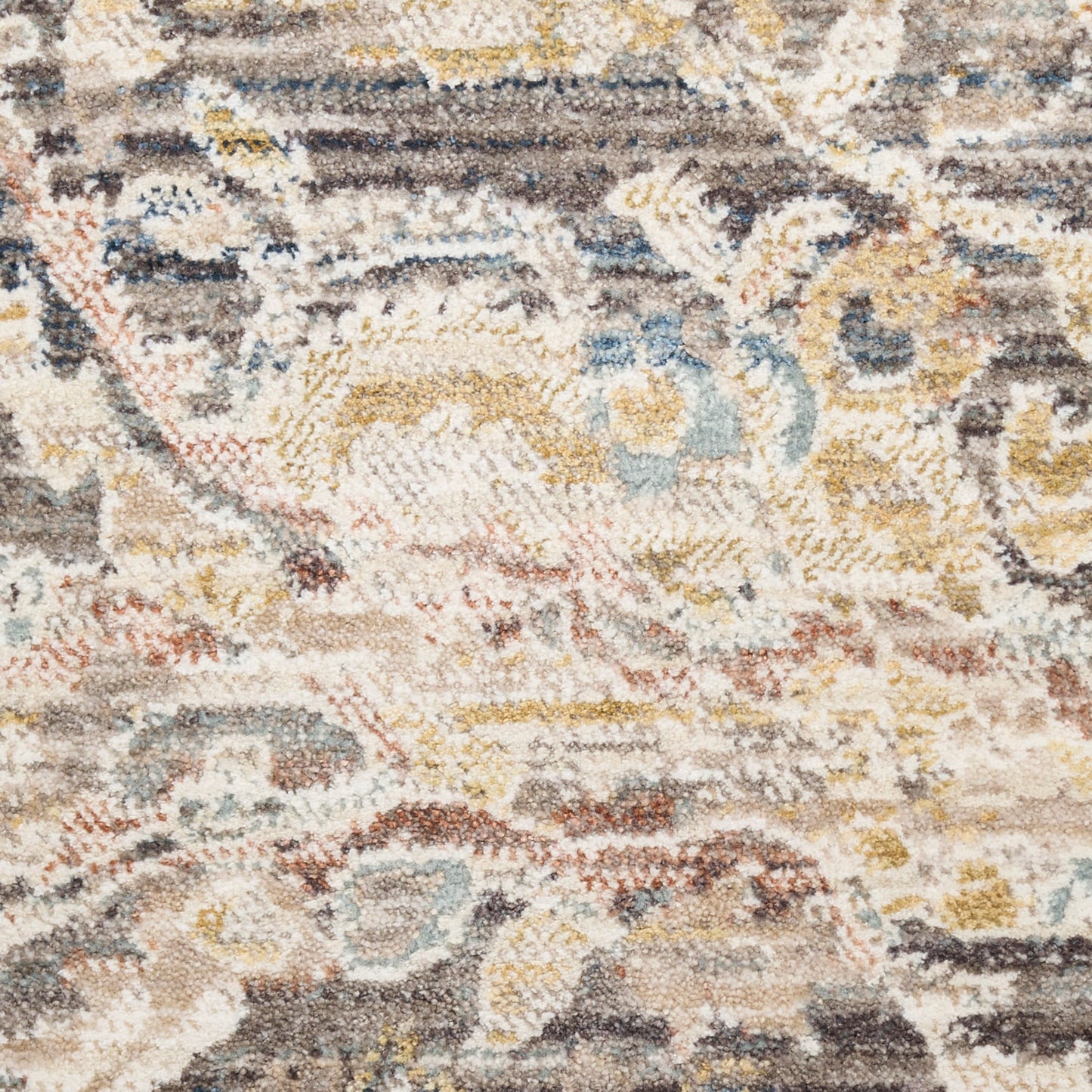 Distressed vintage rug with abstract floral-geometric pattern in cream, blue, beige, yellow, and brown.