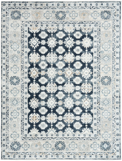Rectangular oriental rug with a dark navy center and white floral medallions, surrounded by ivory and light blue borders.