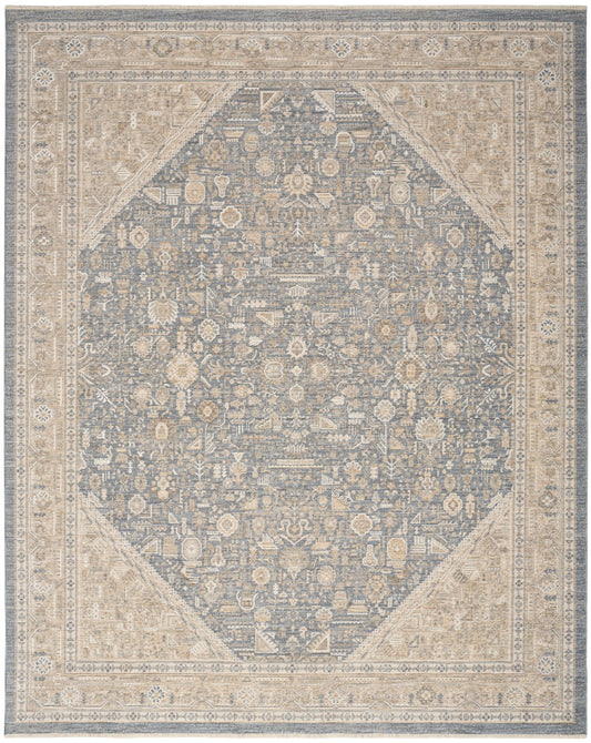 Blue-gray oriental rug with cream border and ornate floral motifs; diamond-centered central field.