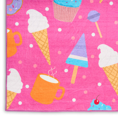 Bright pink kids rug with a dessert-print design: ice cream cones, cupcakes, popsicles, a mug and a donut.
