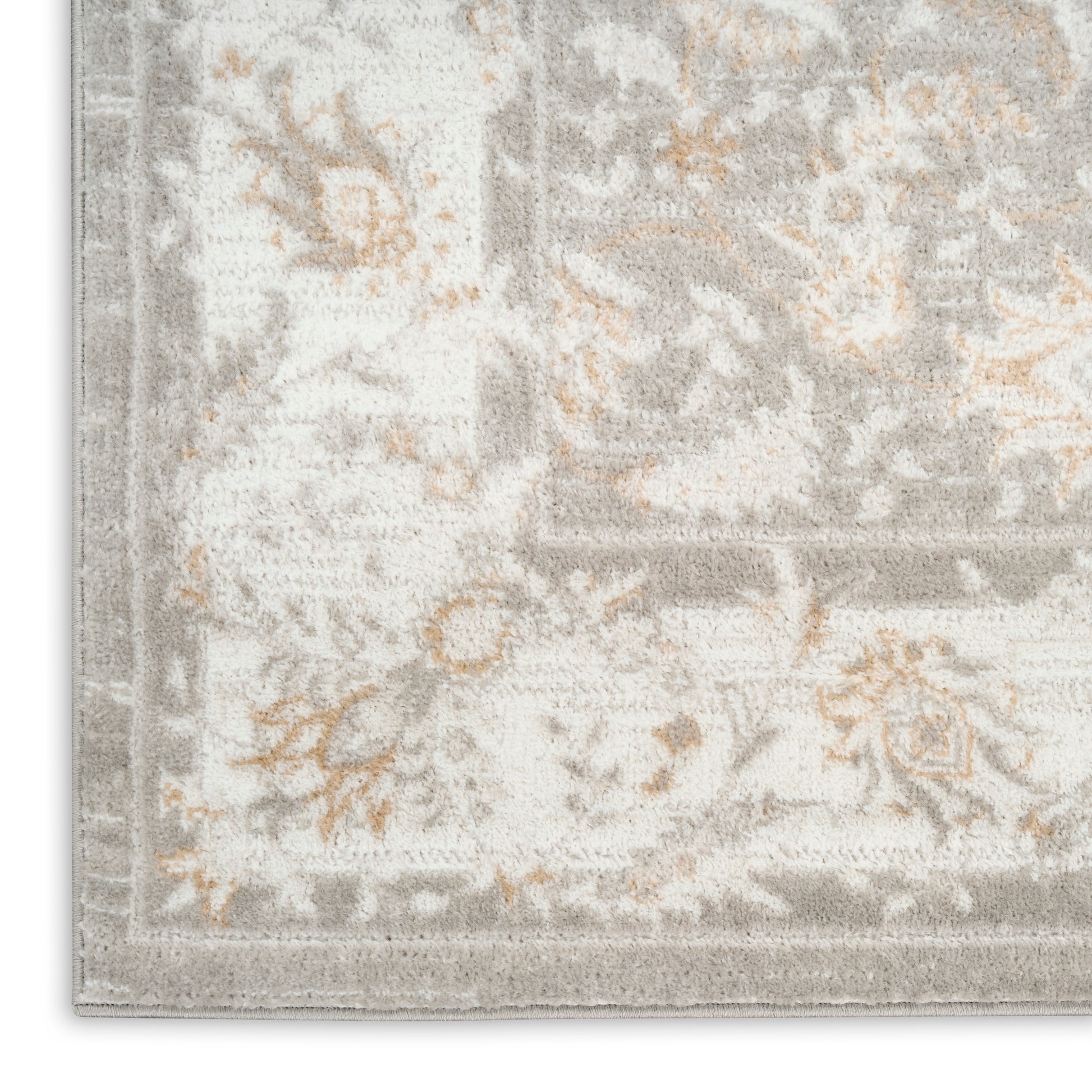 Light gray and ivory patterned area rug with subtle orange floral accents in a traditional damask style.