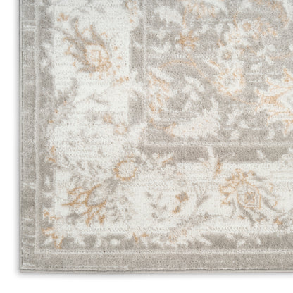 Light gray and ivory patterned area rug with subtle orange floral accents in a traditional damask style.