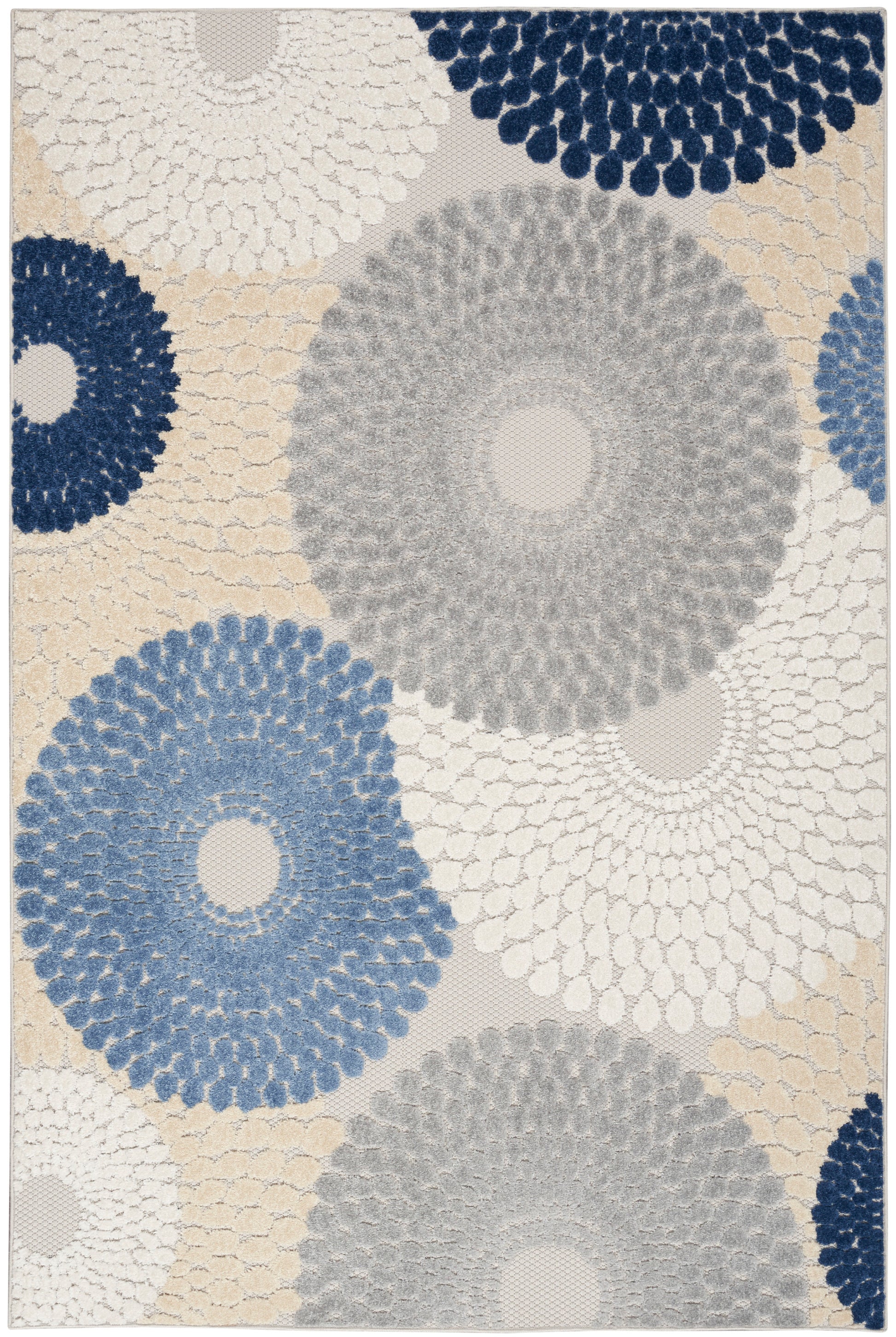 Tufted area rug with large circular floral patterns in navy, blue, gray and beige on a light background; textured modern design.