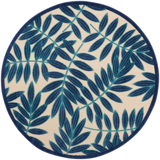 Round rug with navy blue leafy pattern on beige background and a dark blue edge.