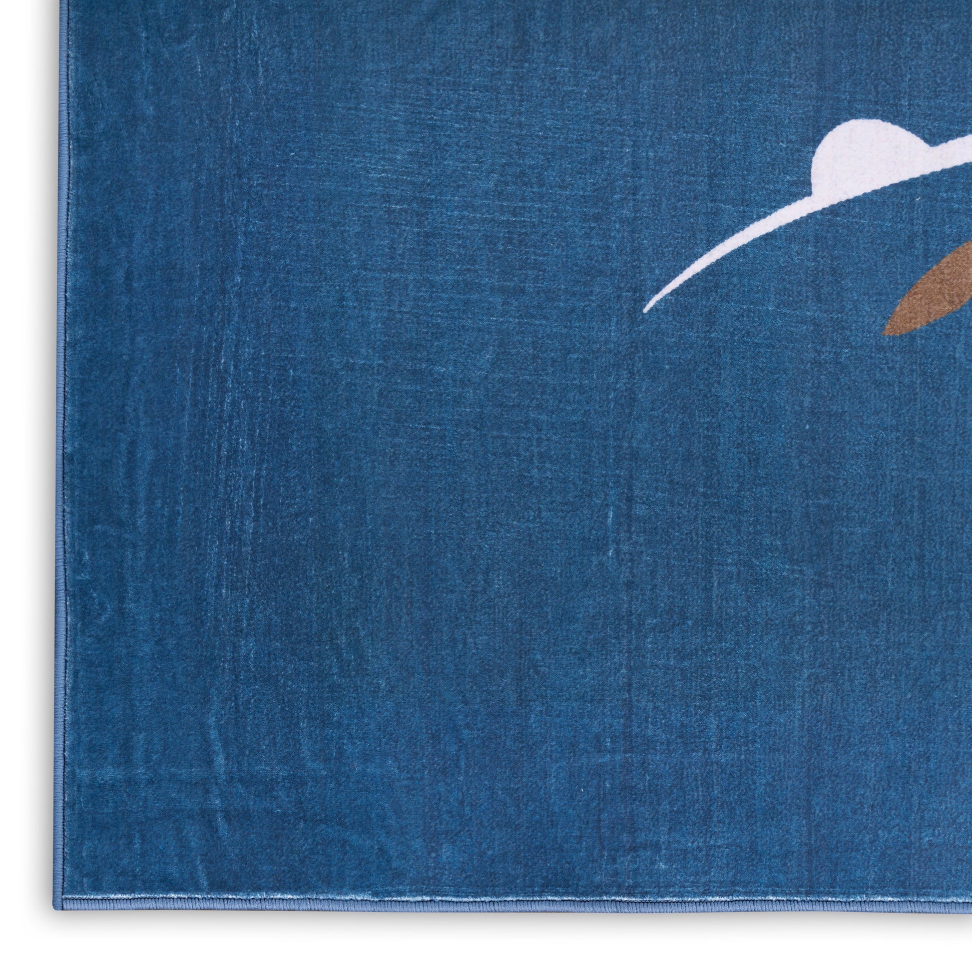 Blue linen-textured notebook cover with a white curved line and brown leaf accent; journal-style design.