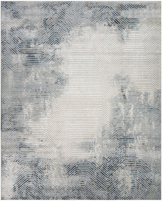 Blue-gray abstract area rug with a faded chevron/herringbone pattern & soft washed texture.