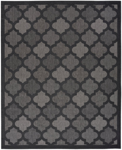 Dark gray & black geometric quattrofoil trellis rug with a textured woven pattern & border