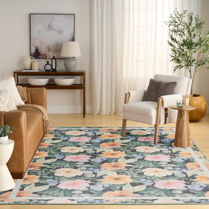 Floral area rug with blue-green background, pink and cream blooms, and green leaves; border for a mid-century living room.