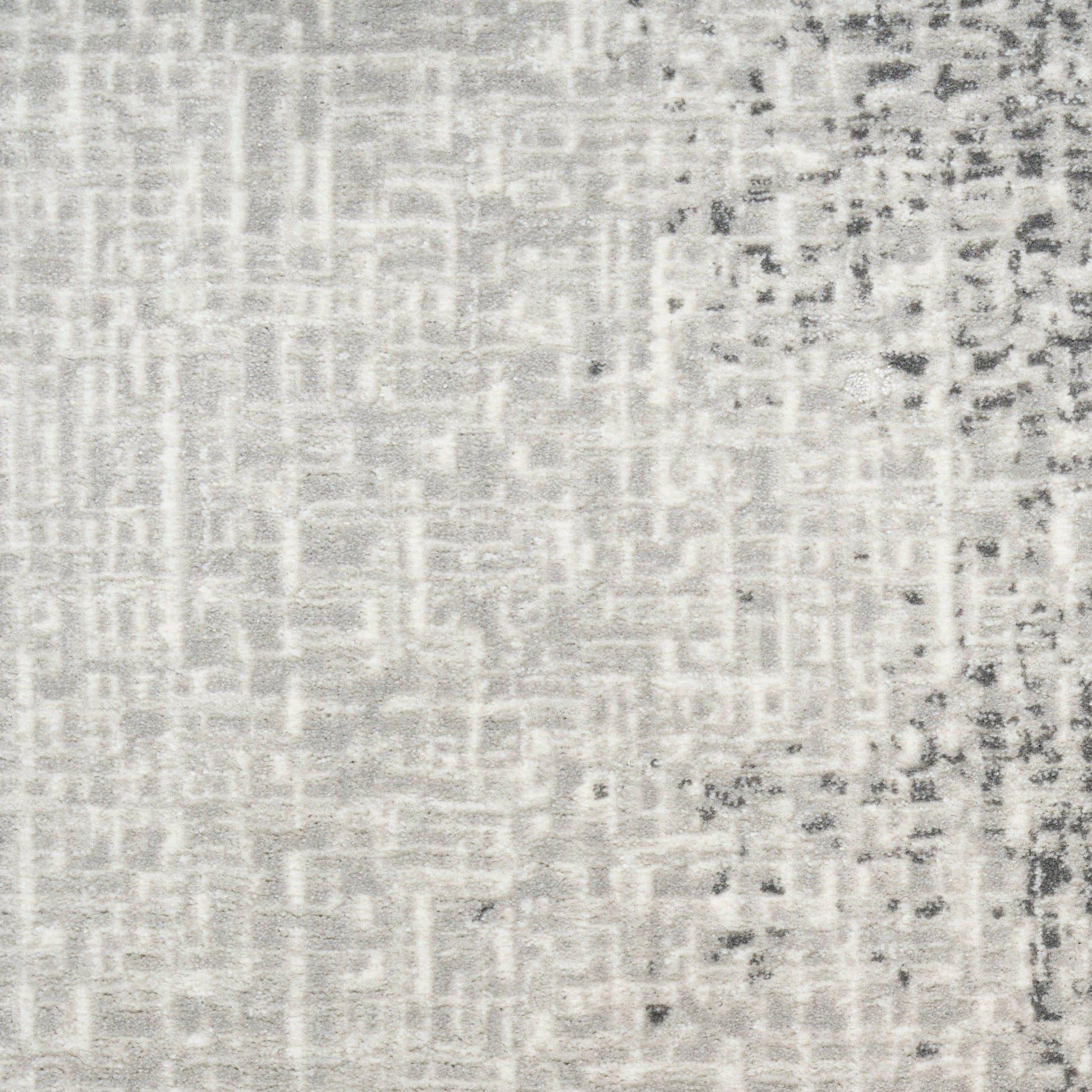 Gray woven rug texture with a subtle geometric pattern; light base with a darker speckled right edge.