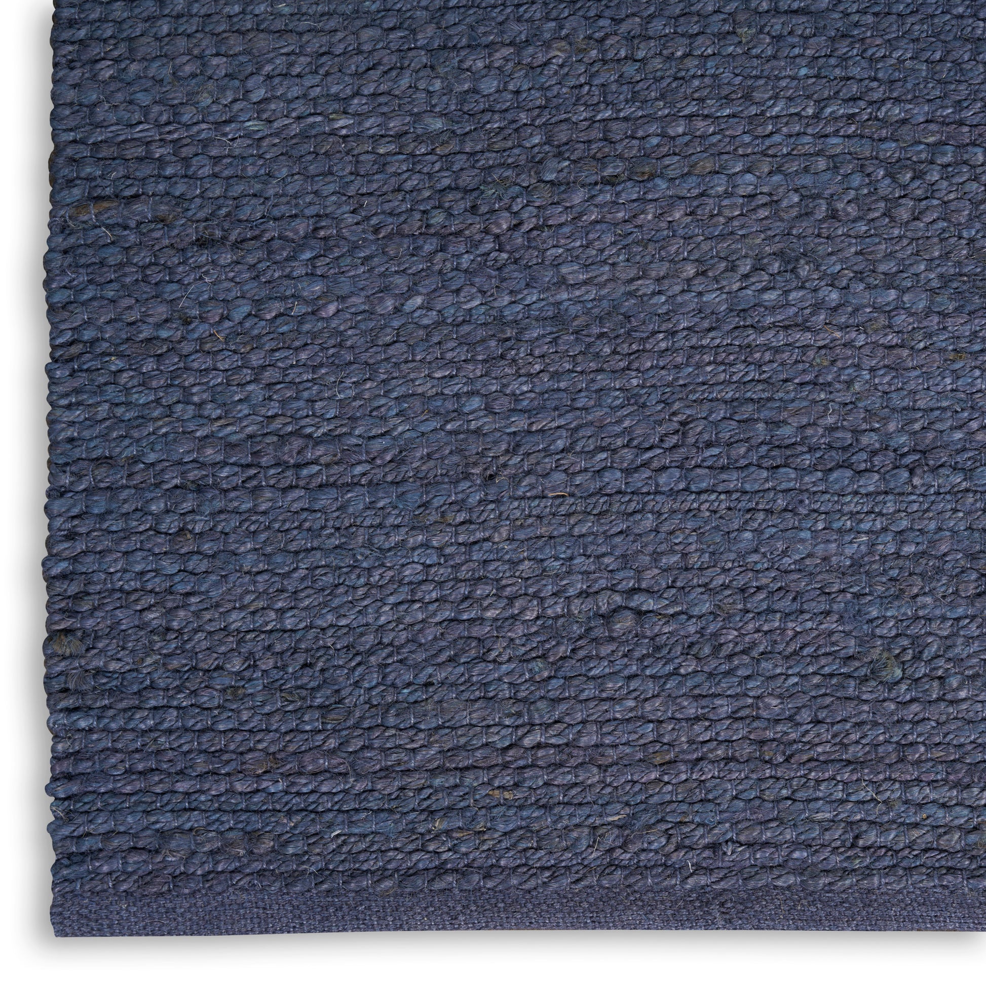 Close-up of navy blue textured loop-pile fabric with dense weave, ideal for rug or upholstery.